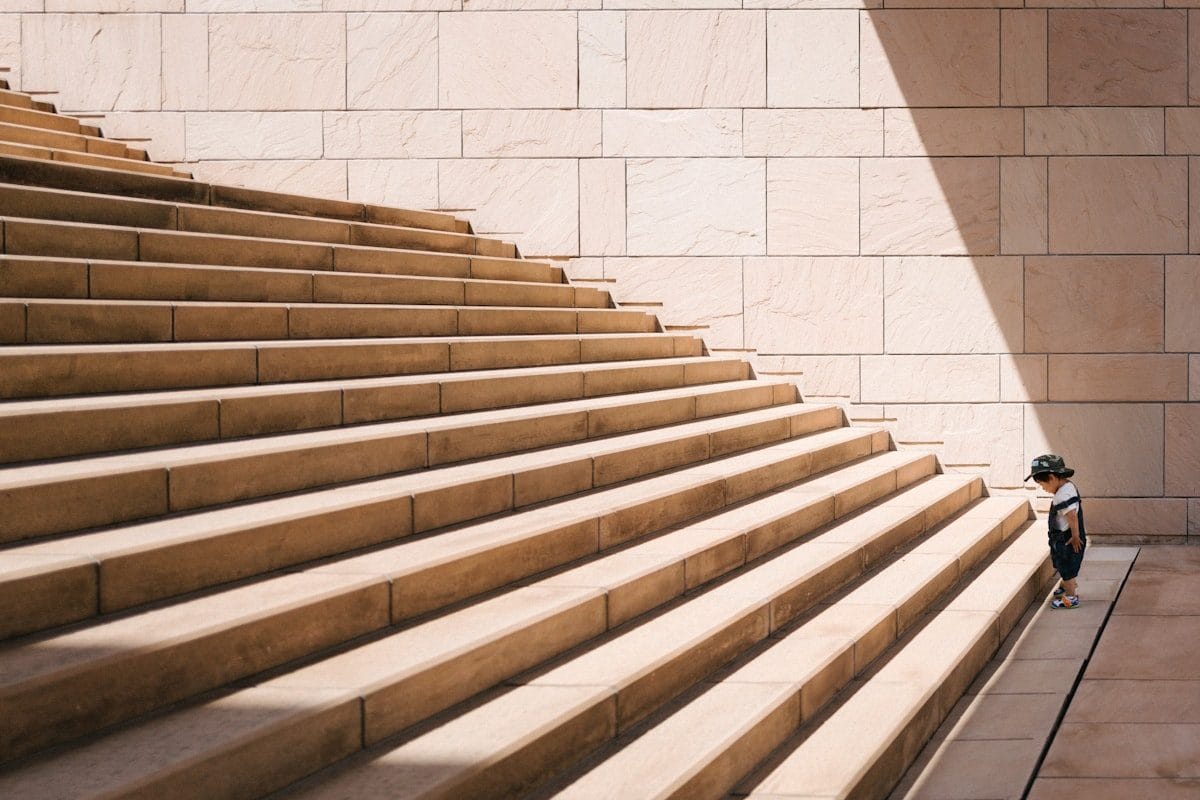 Ascending stairs with light ahead — representing career progression and the next step forward