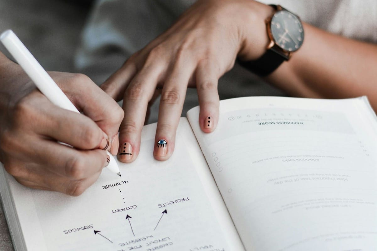 A person reflecting with a journal — the inward work that powers an authentic "what motivates you" answer