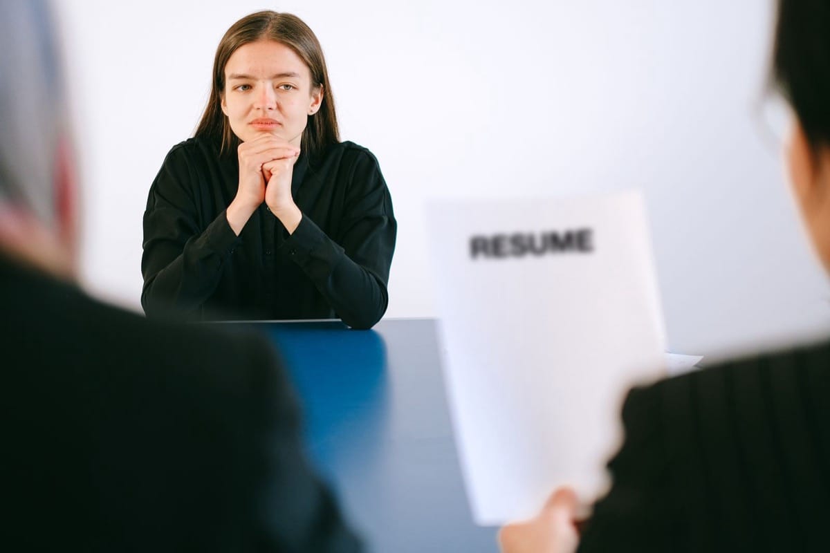 A candidate addressing a panel of interviewers across a table: managing a room rather than a single conversation