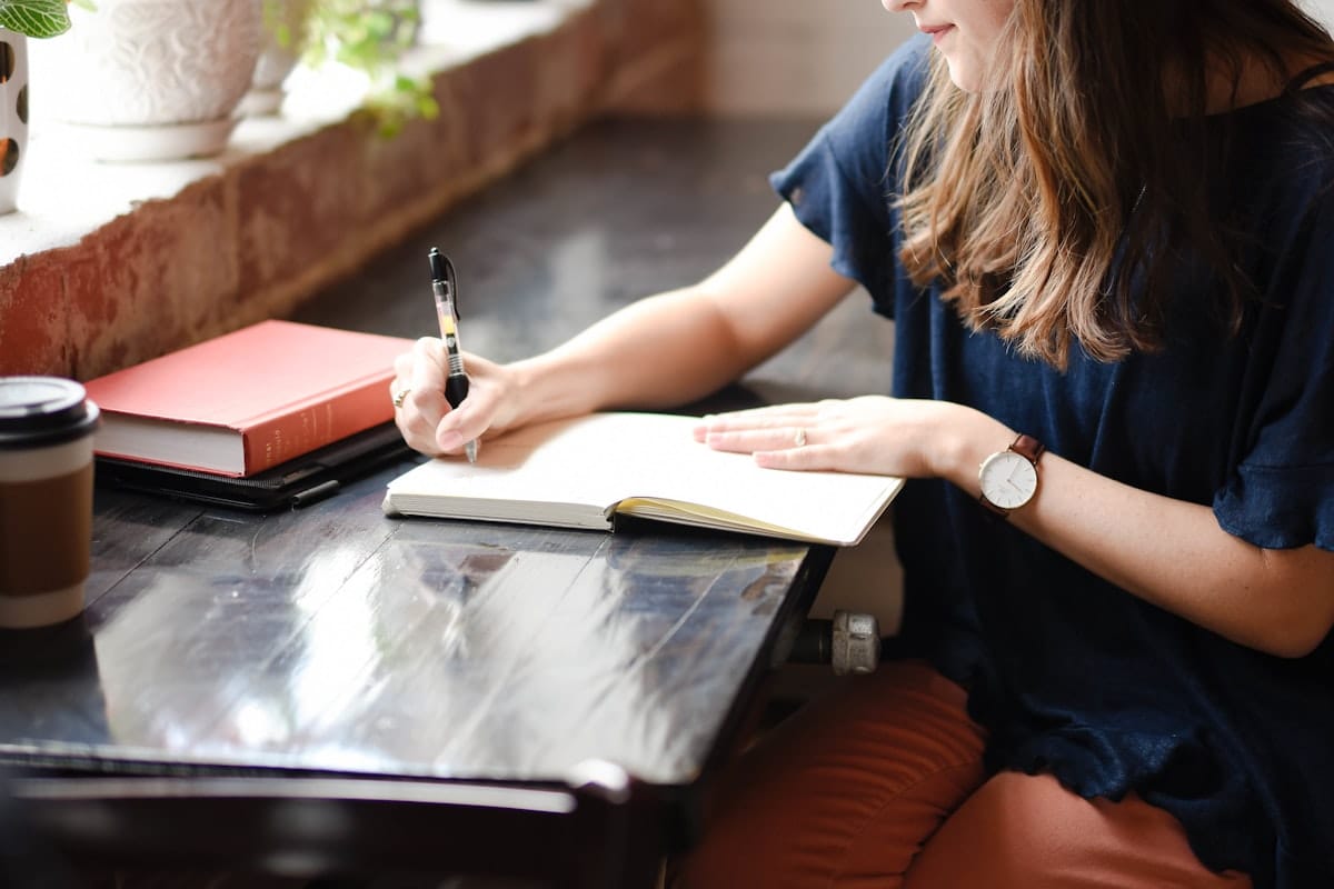 A person reflecting with a journal: the inward work that powers an authentic "what motivates you" answer