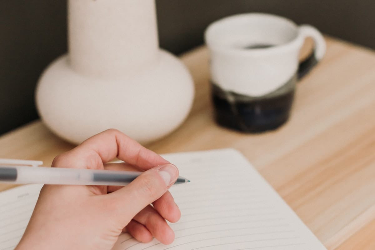 A candidate preparing notes at a clean desk before an Apple interview, working through career stories