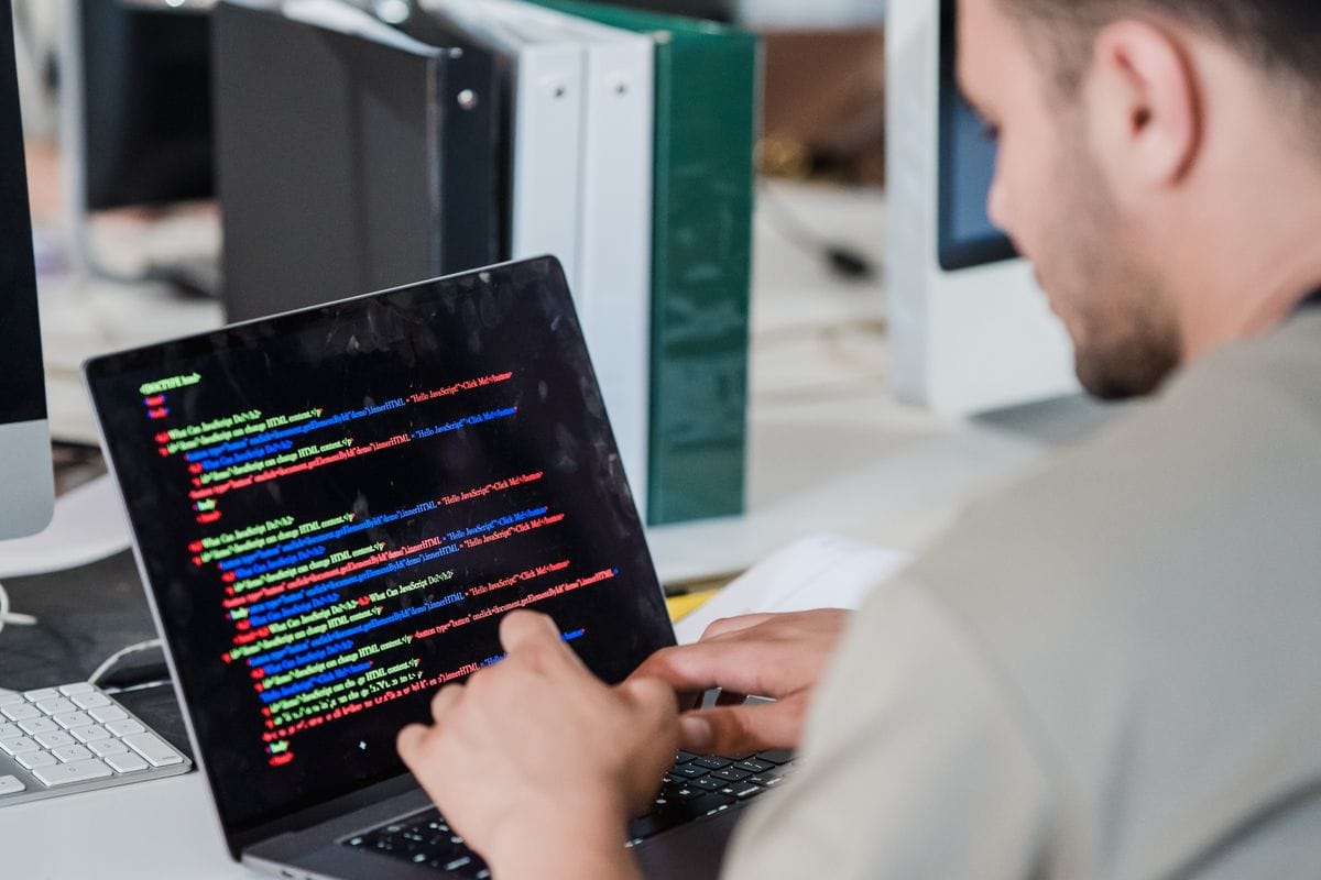 Software engineer working on code at a laptop before a behavioral interview
