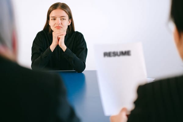 A candidate addressing a panel of interviewers across a table: managing a room rather than a single conversation