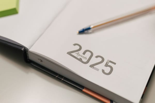 Open agenda planner with a pen used to map out a consulting recruiting timeline