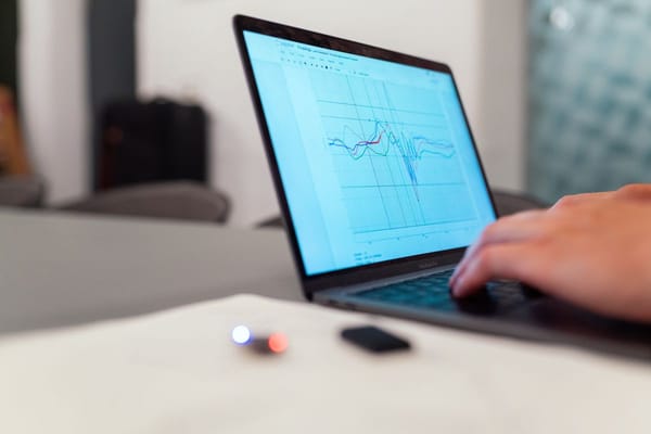Data scientist analyzing a chart on a laptop while preparing for a data science interview